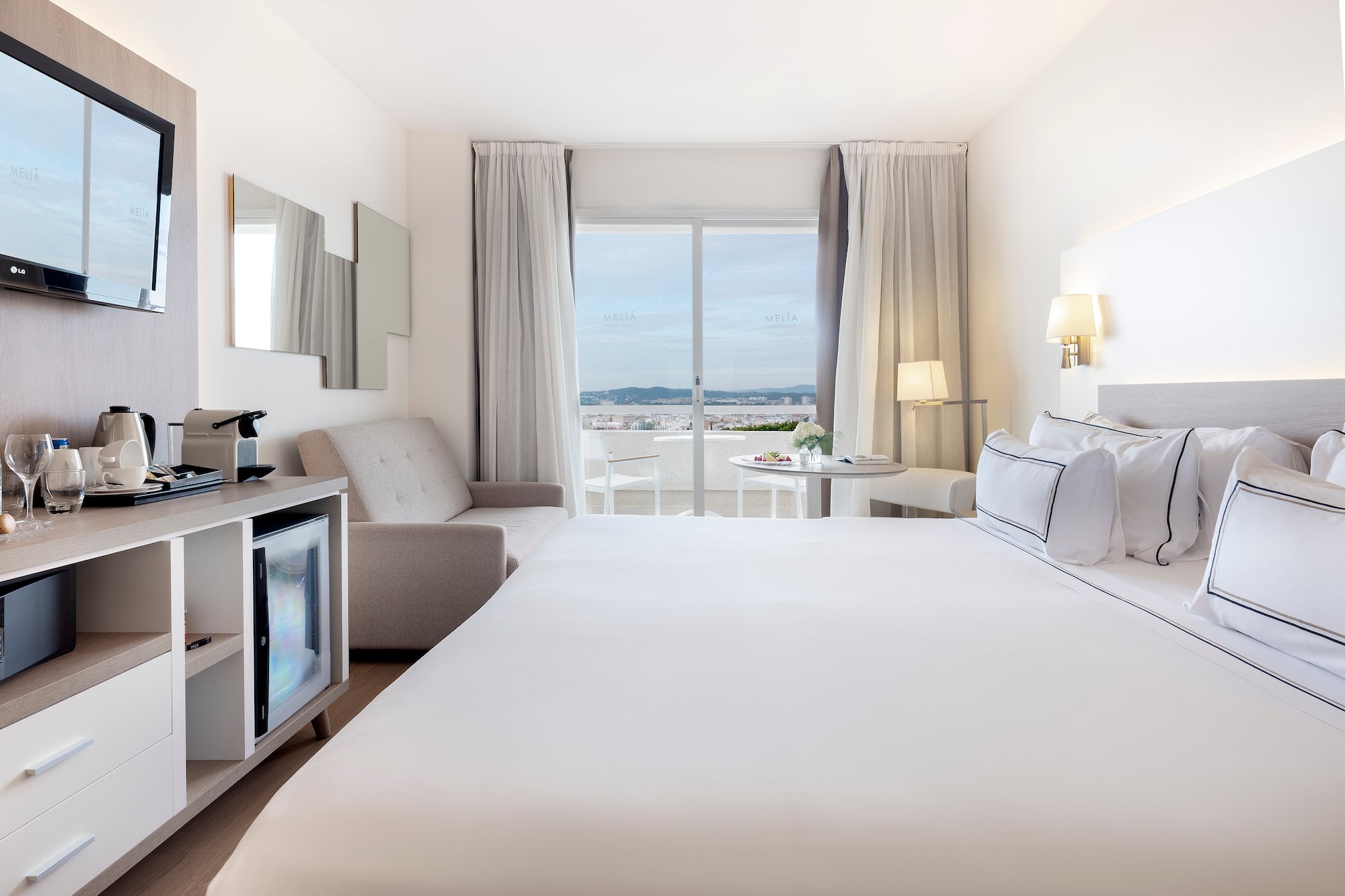 a room with a bed and a television