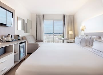 a room with a bed and a television