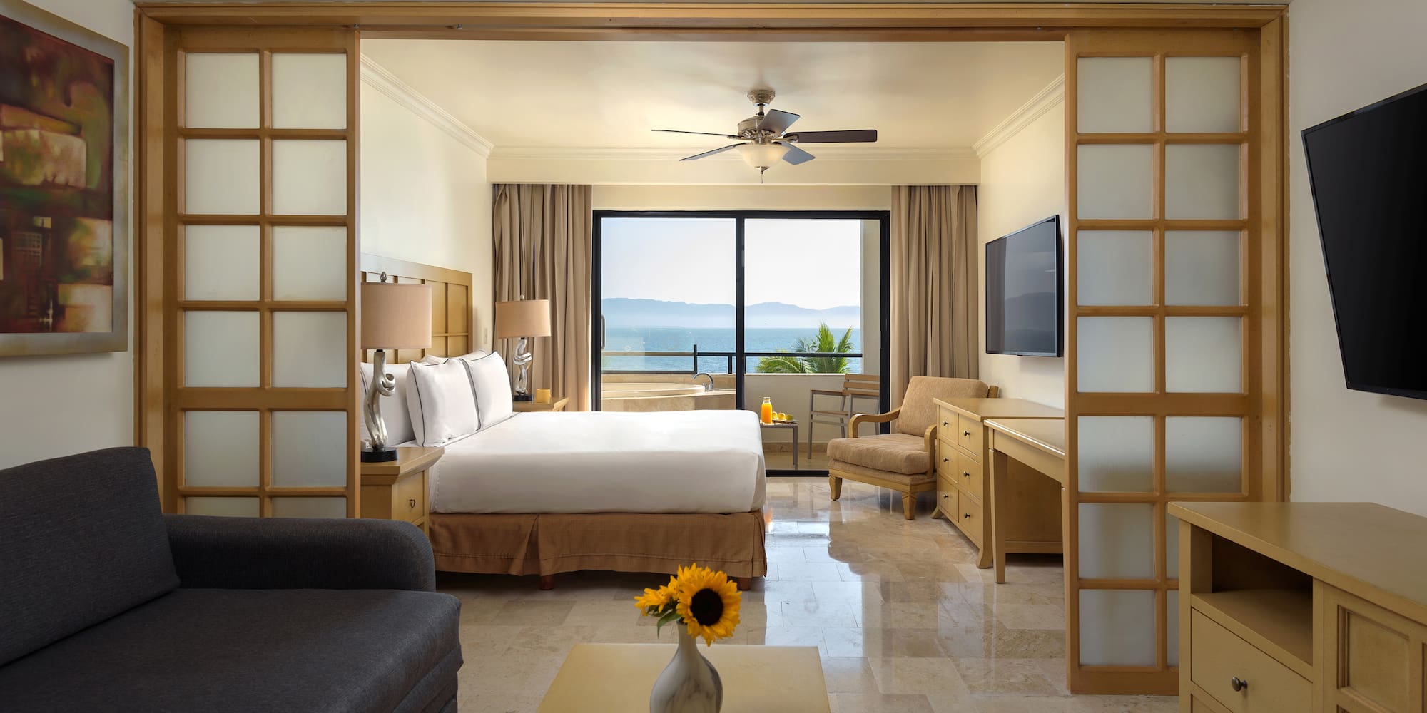 a room with a bed and a television