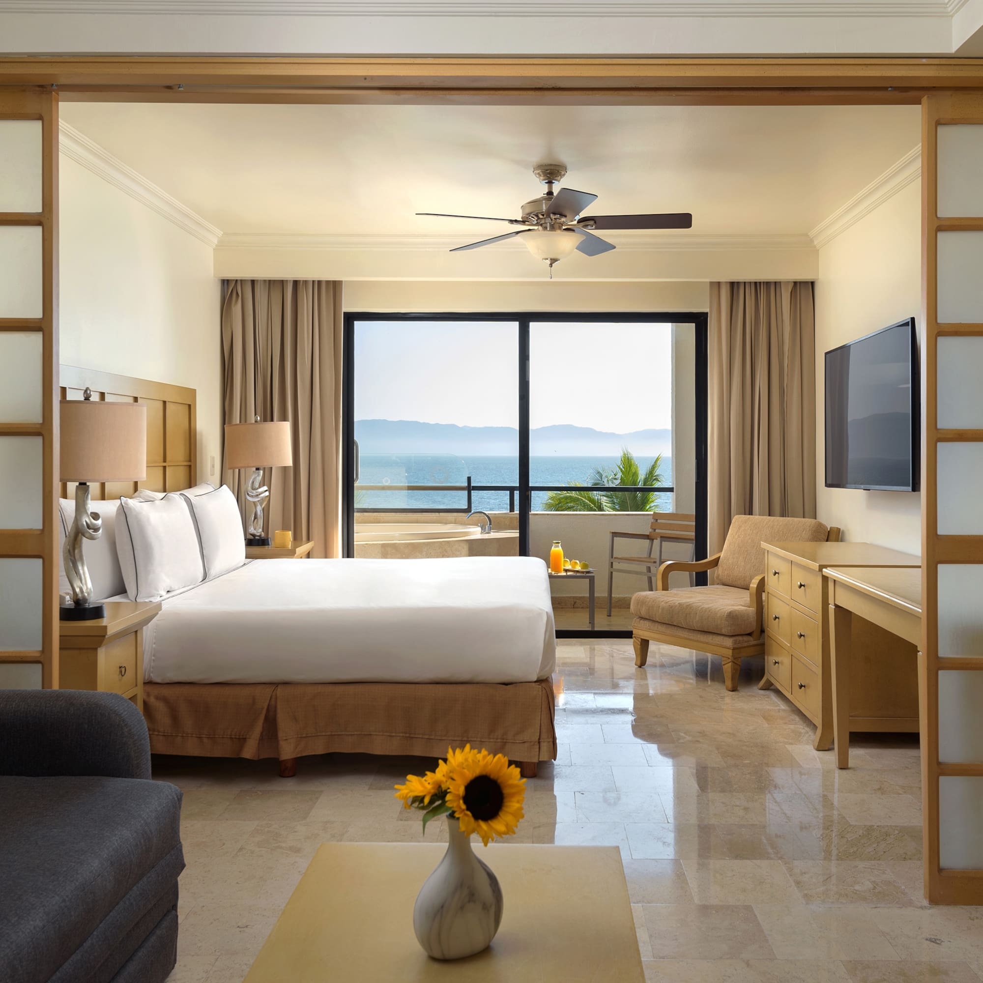 a room with a bed and a television