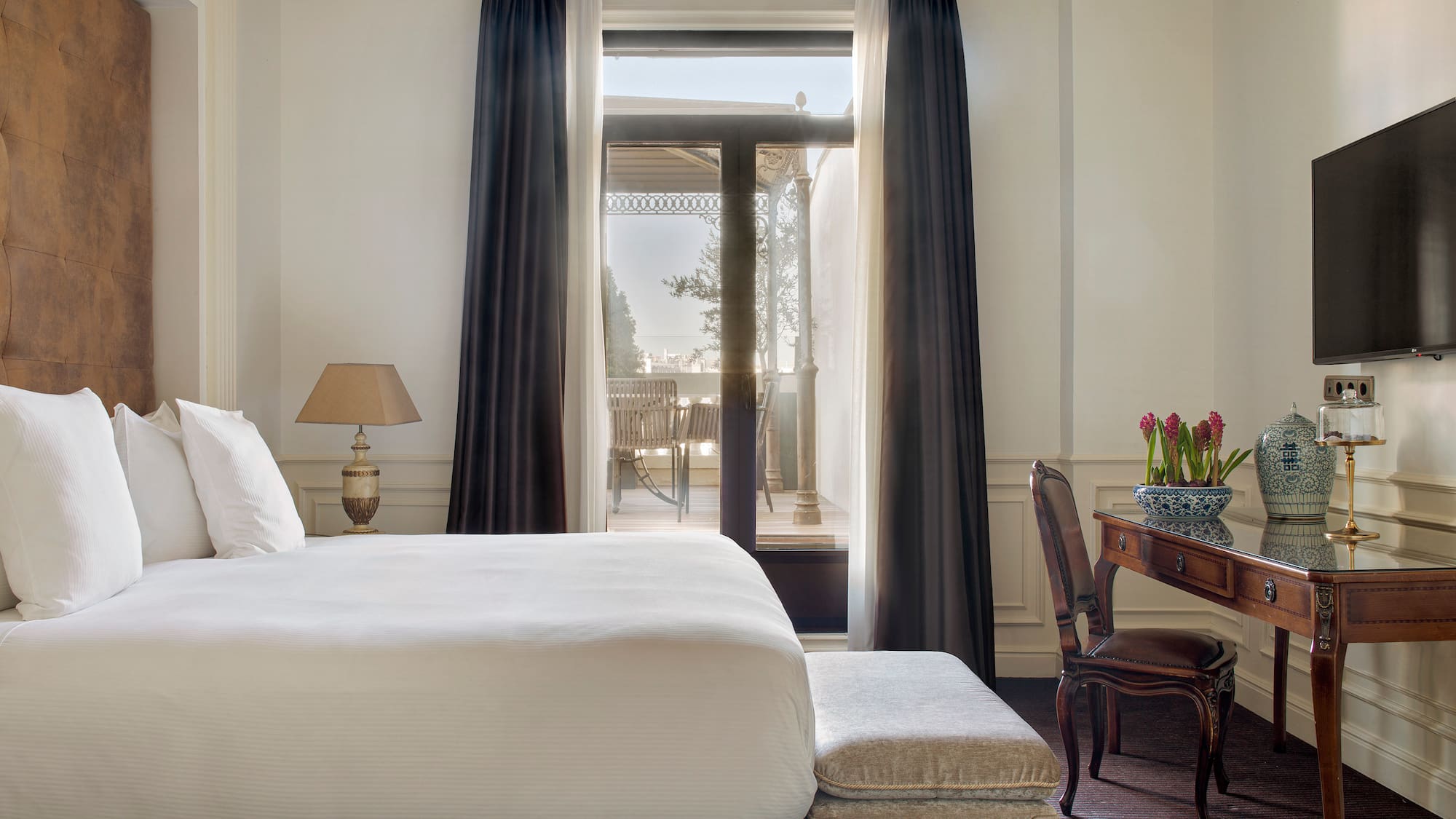 a bedroom with a desk and a bed