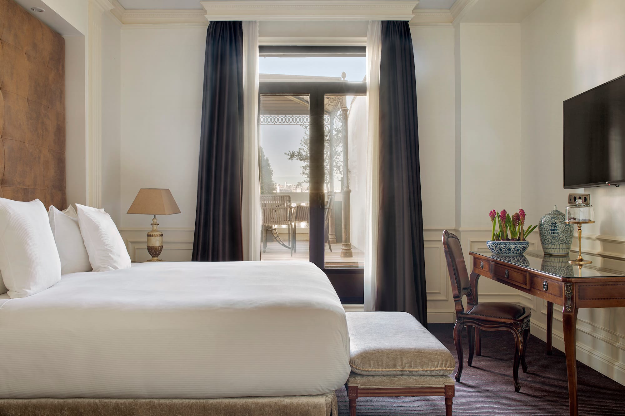 a bedroom with a desk and a bed