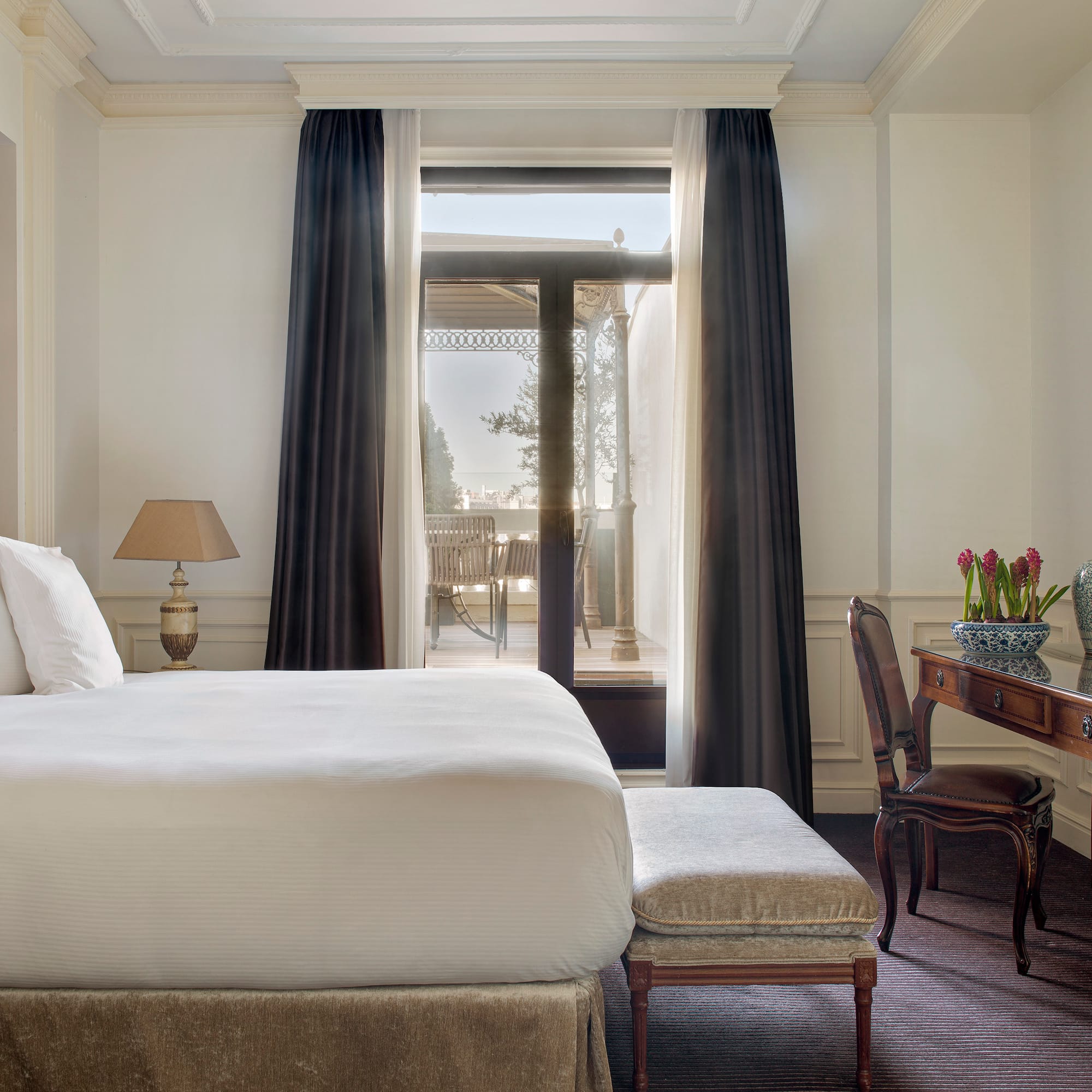 a bedroom with a desk and a bed