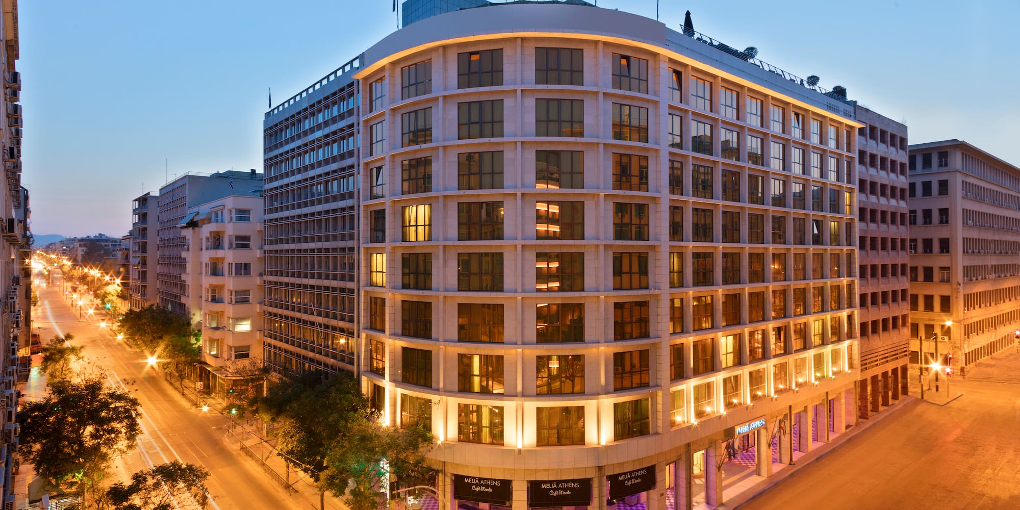 a building with many windows and a street in the background