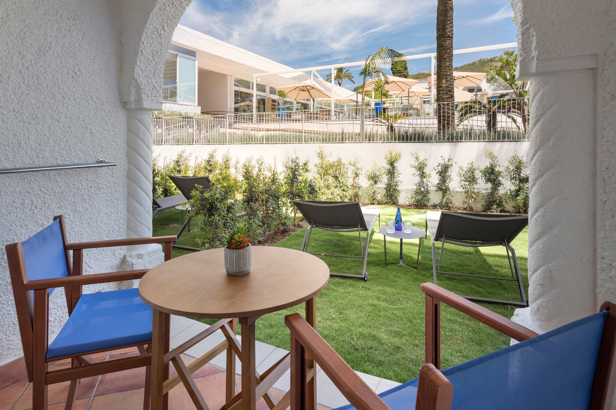 a patio area with chairs and tables
