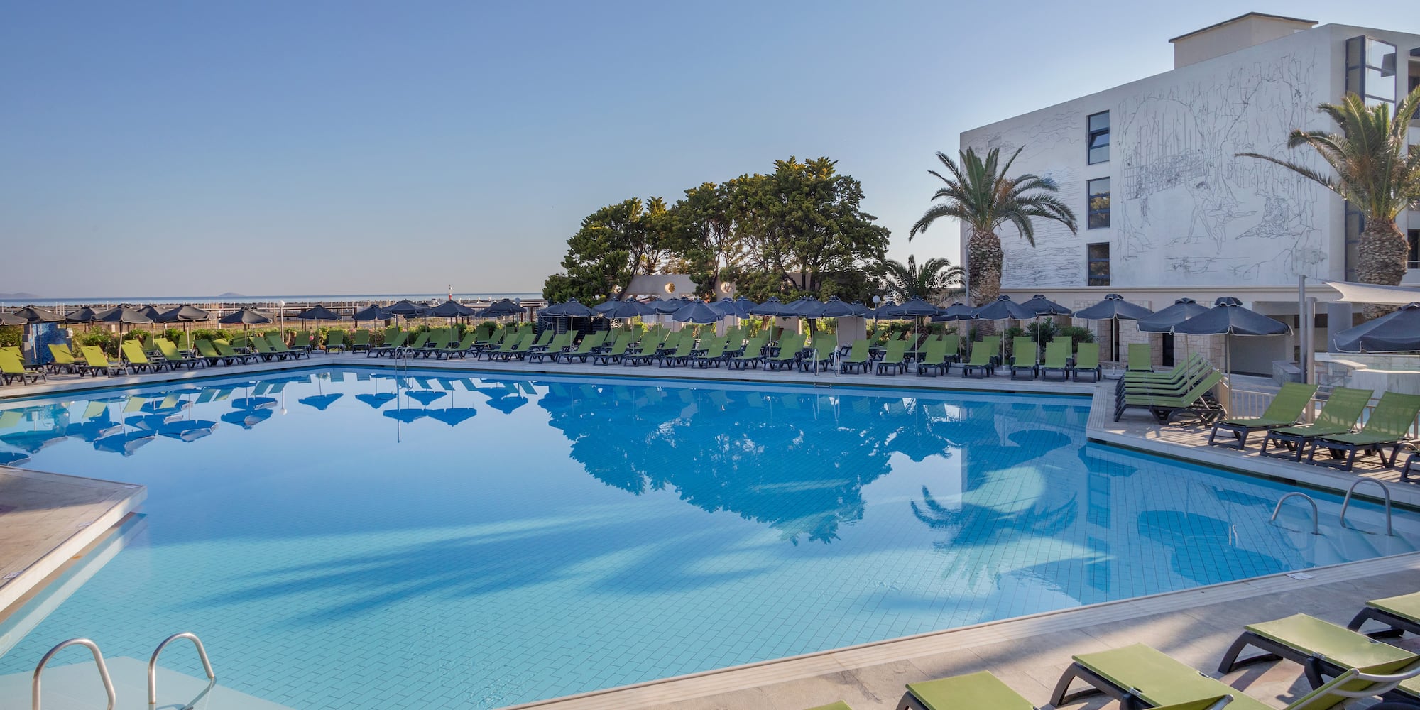 a pool with chairs and umbrellas