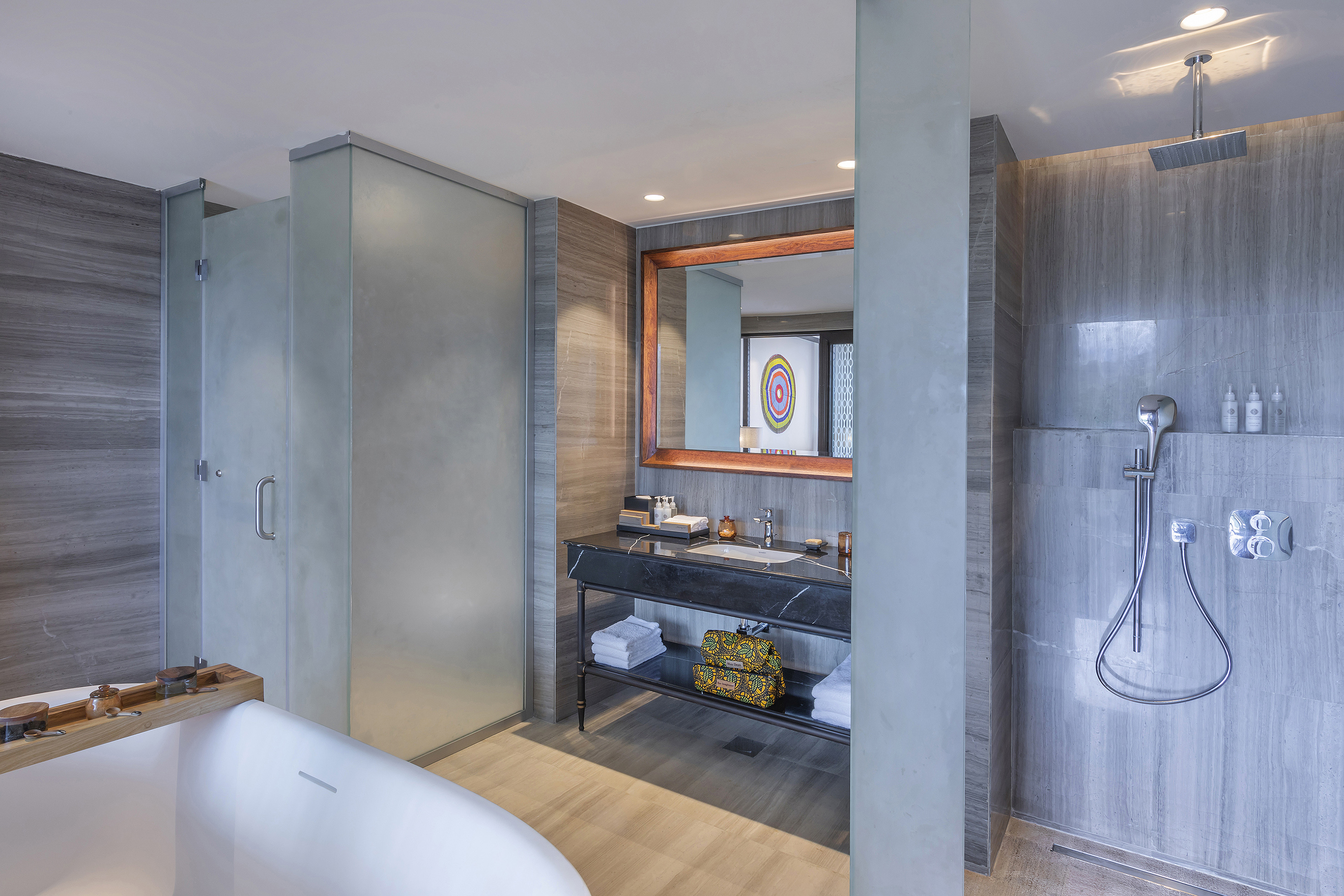 Modern luxury bathroom with freestanding tub, vanity, and walk-in shower.
