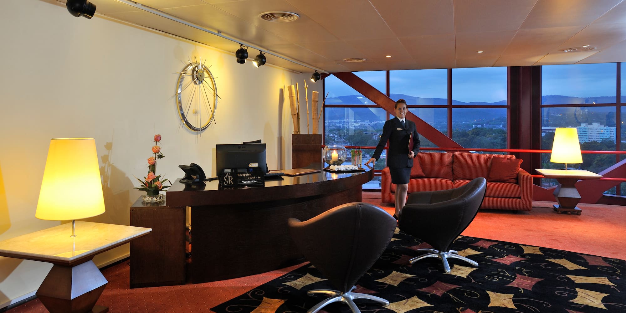 a woman standing in a hotel lobby