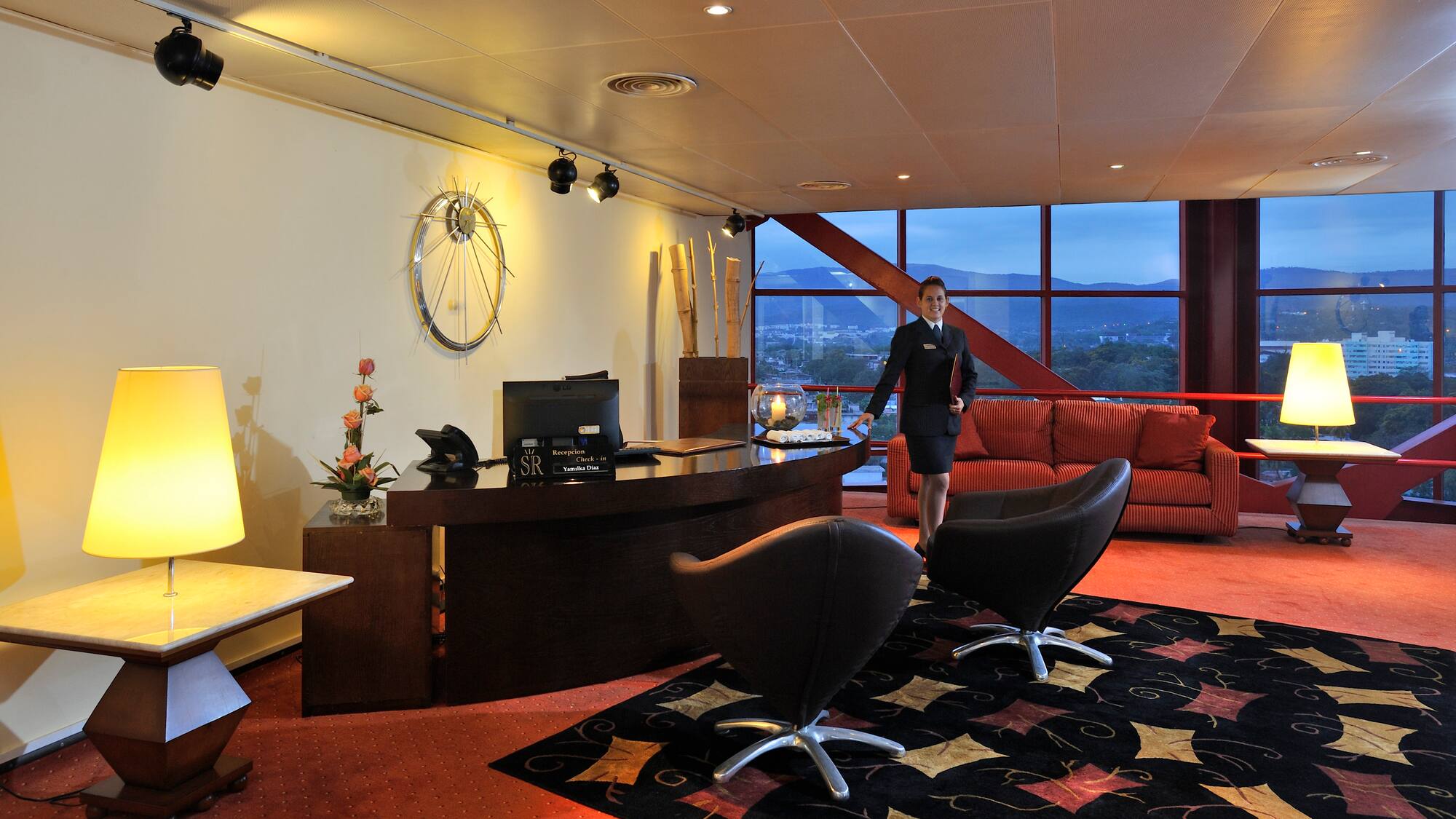 a woman standing in a hotel lobby