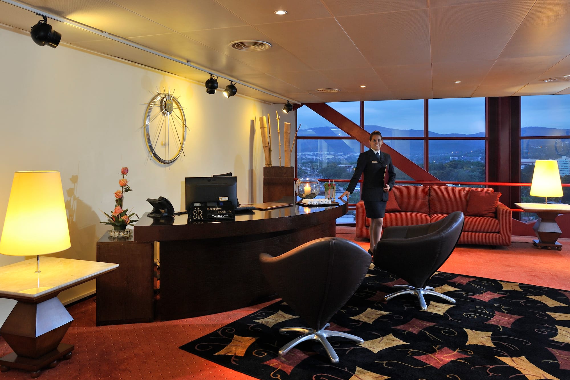 a woman standing in a hotel lobby