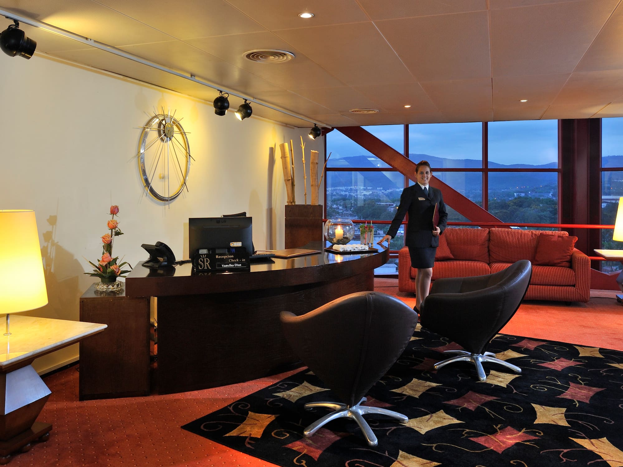a woman standing in a hotel lobby