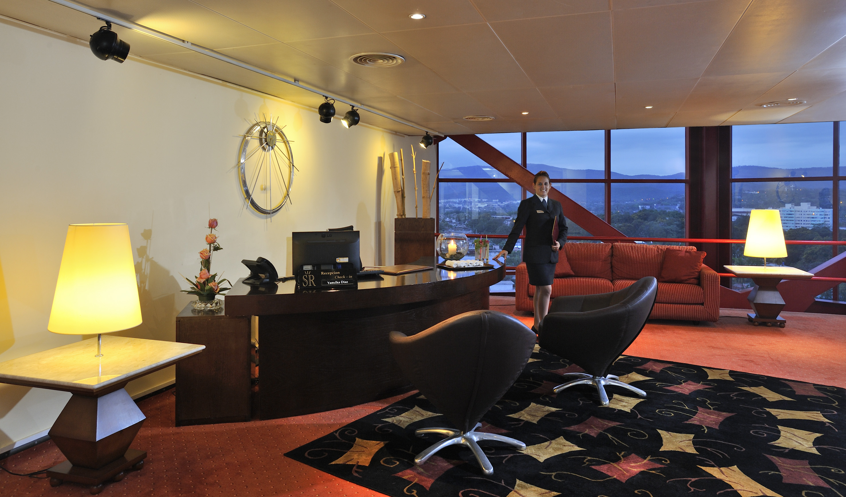 Let yourself be carried away by a world of distinction and exclusive amenities a woman standing in a hotel lobby