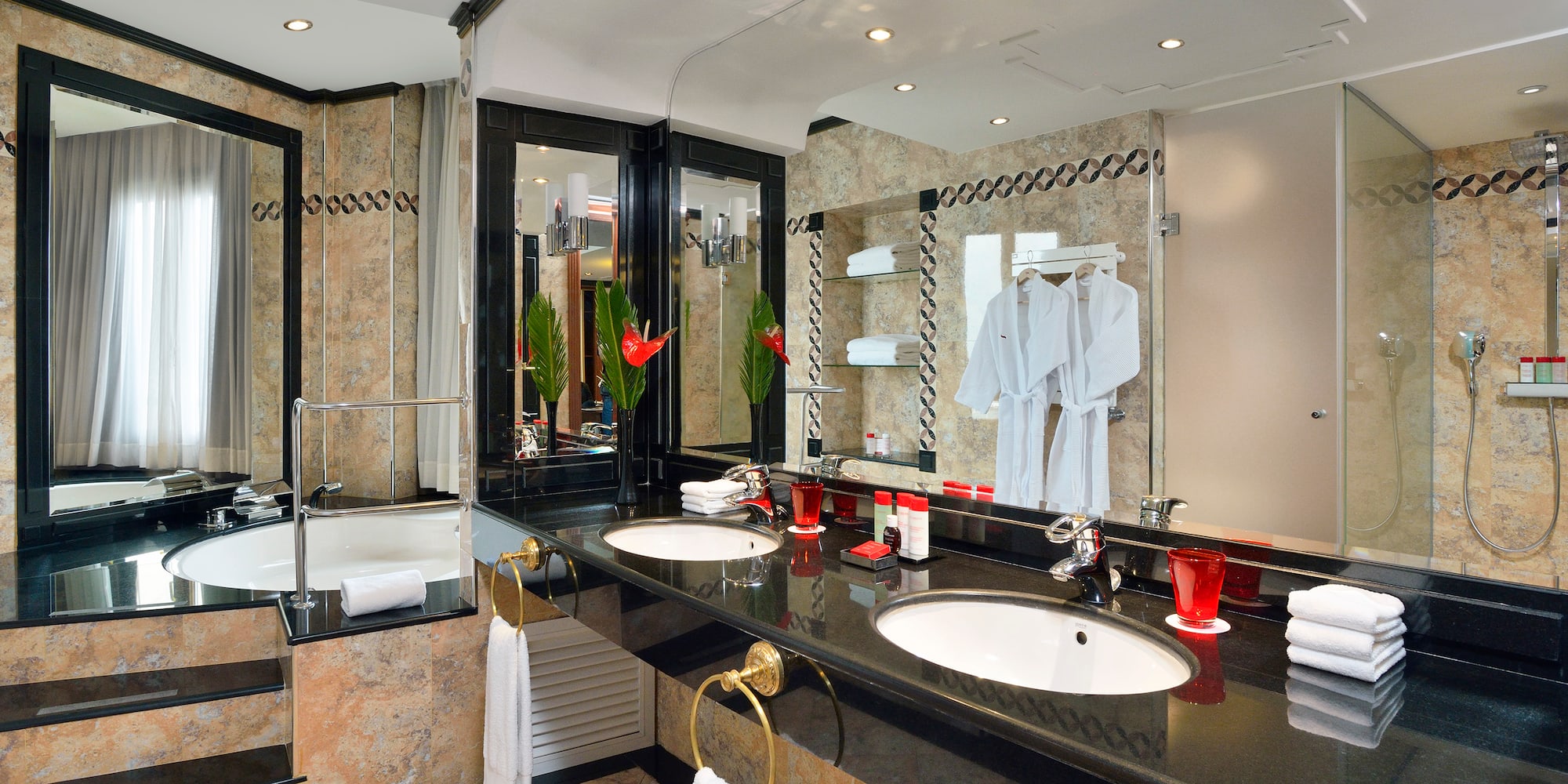 a bathroom with a black countertop and white towels