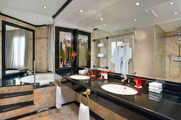 a bathroom with a black countertop and white towels