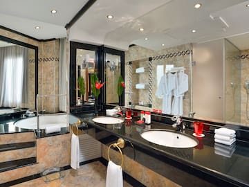 a bathroom with a black countertop and white towels