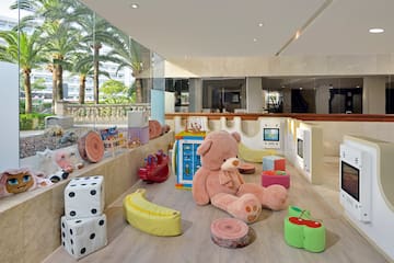 a large stuffed bear and toys in a playroom