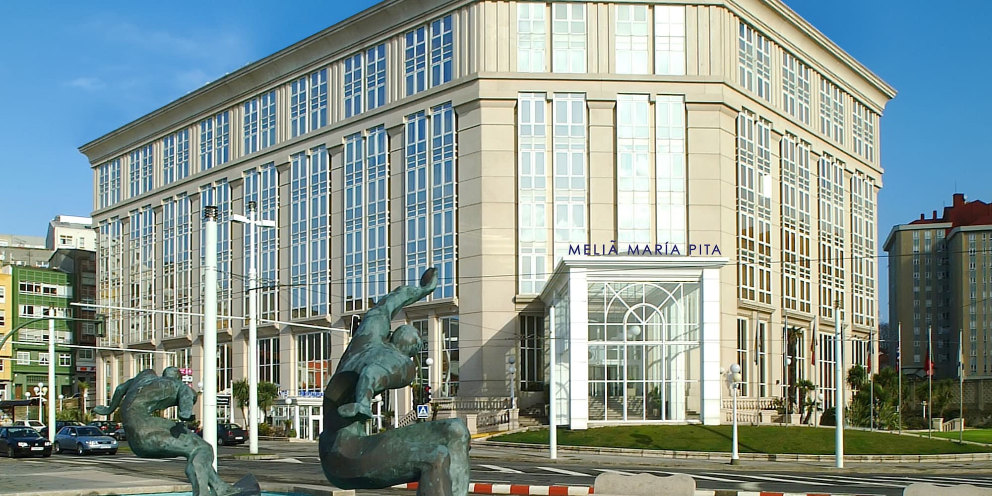 a statue in a fountain in front of a building