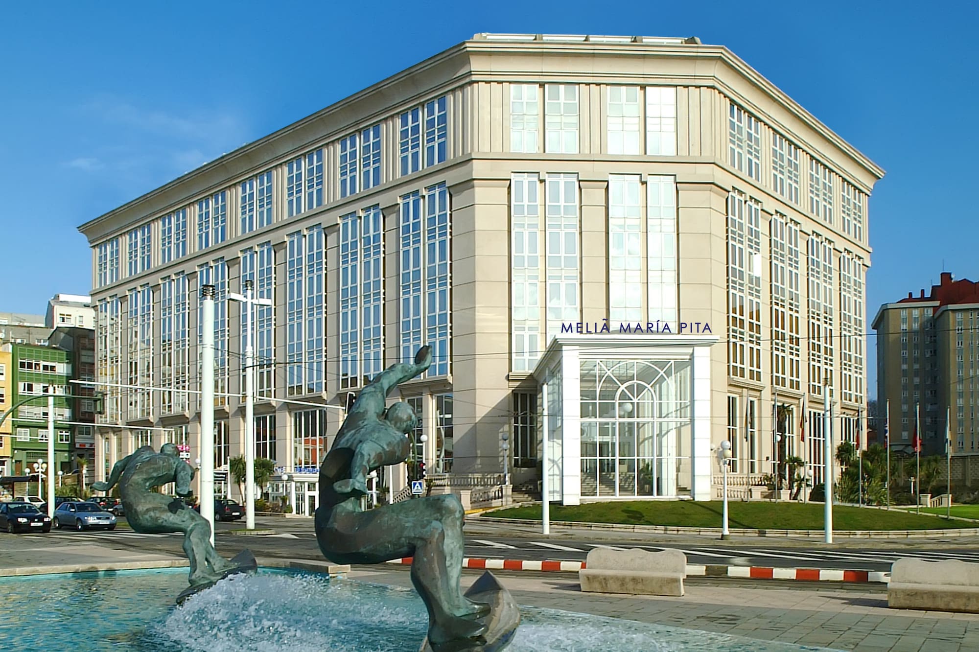 a statue in a fountain in front of a building
