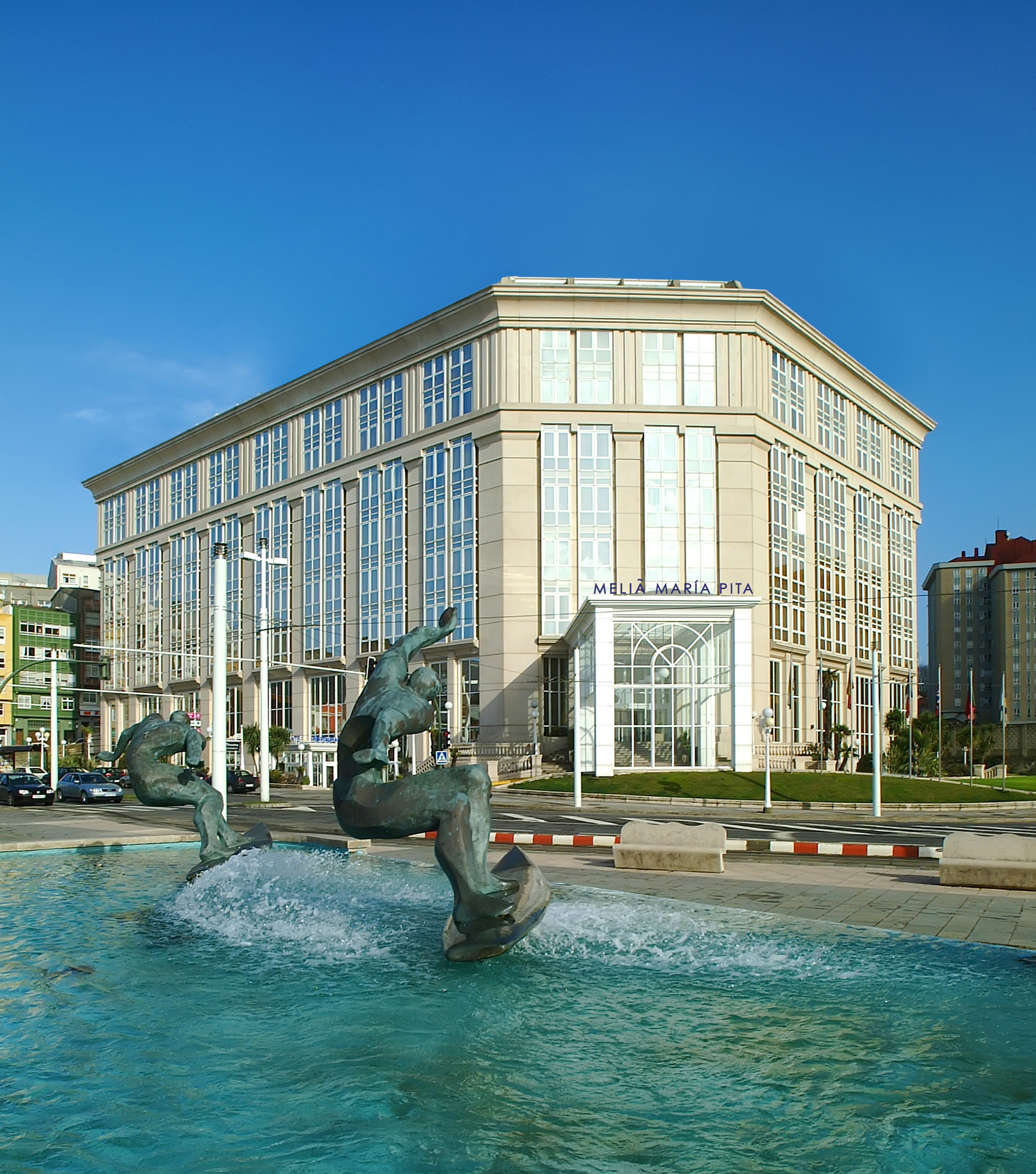 Melia Maria Pita hotel in A Coruña, with water fountain and bronze sculptures.