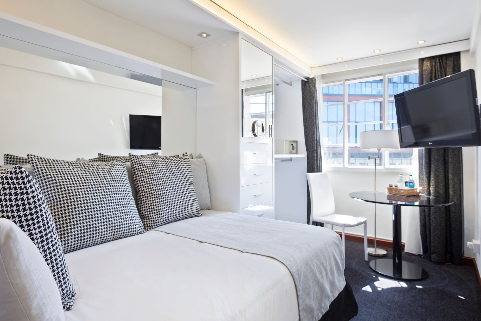 a bedroom with a bed and a desk