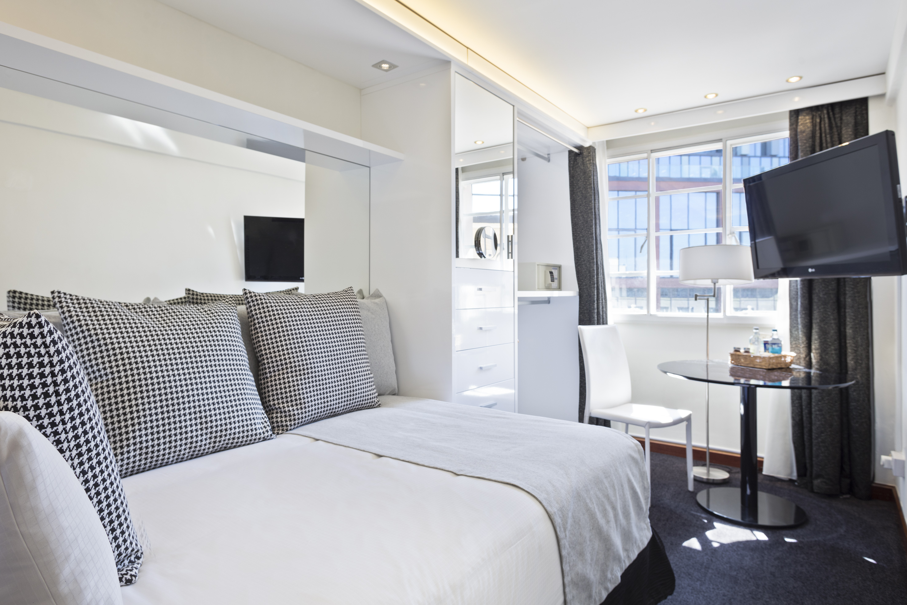 a bedroom with a bed and a desk