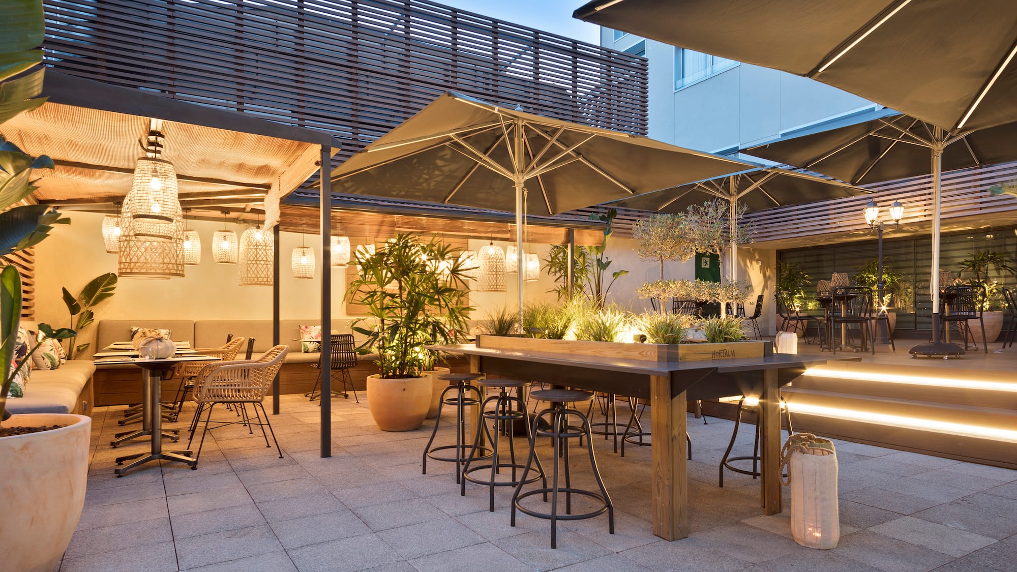 a patio with tables and chairs and umbrellas