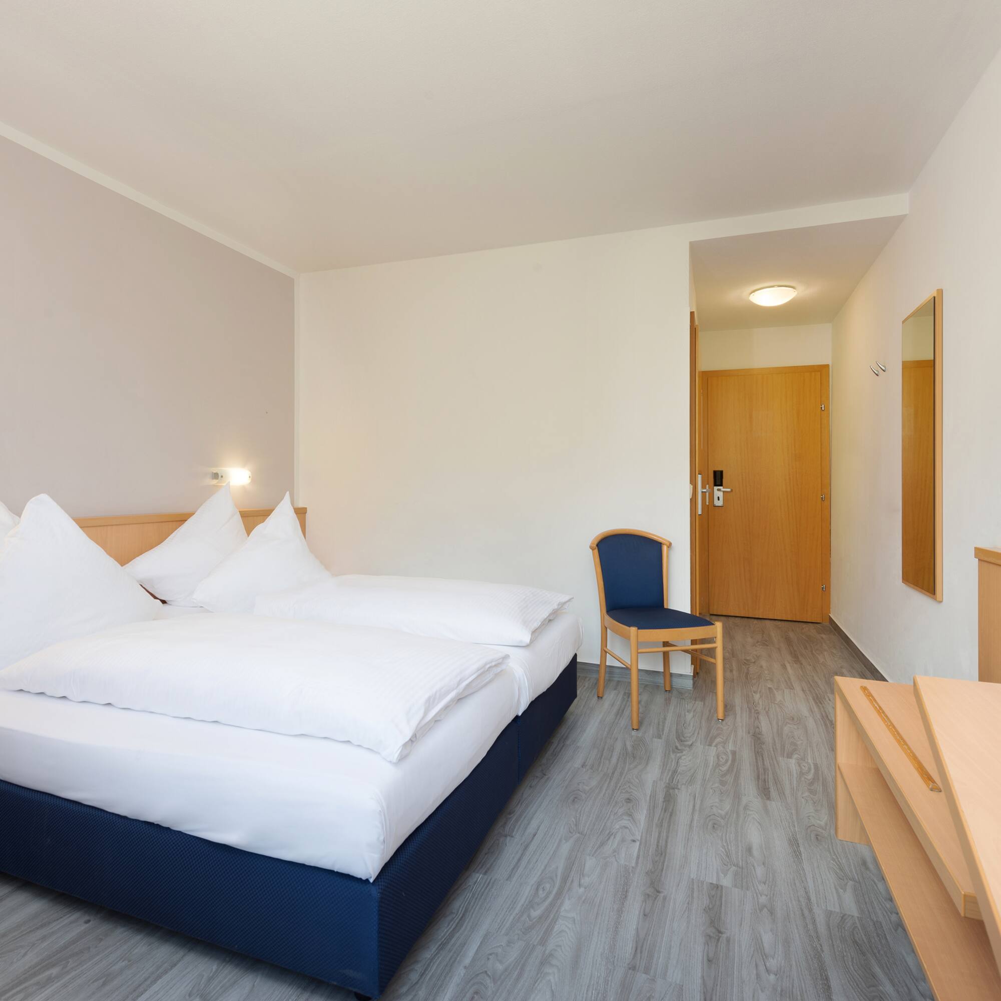 a room with a bed and a chair