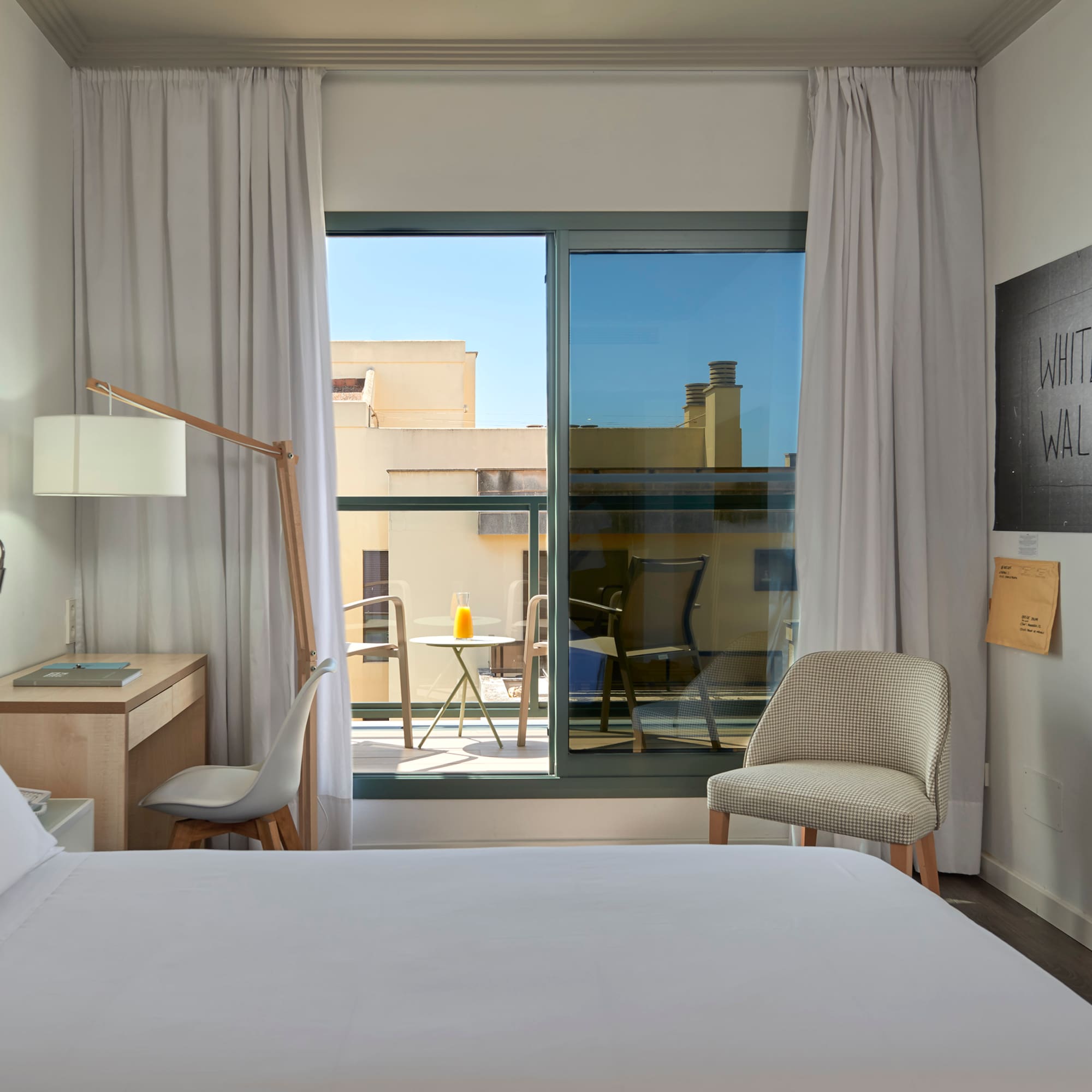 a bedroom with a bed and a chair