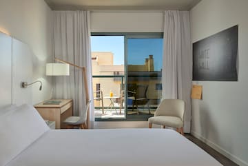 a bedroom with a bed and a chair