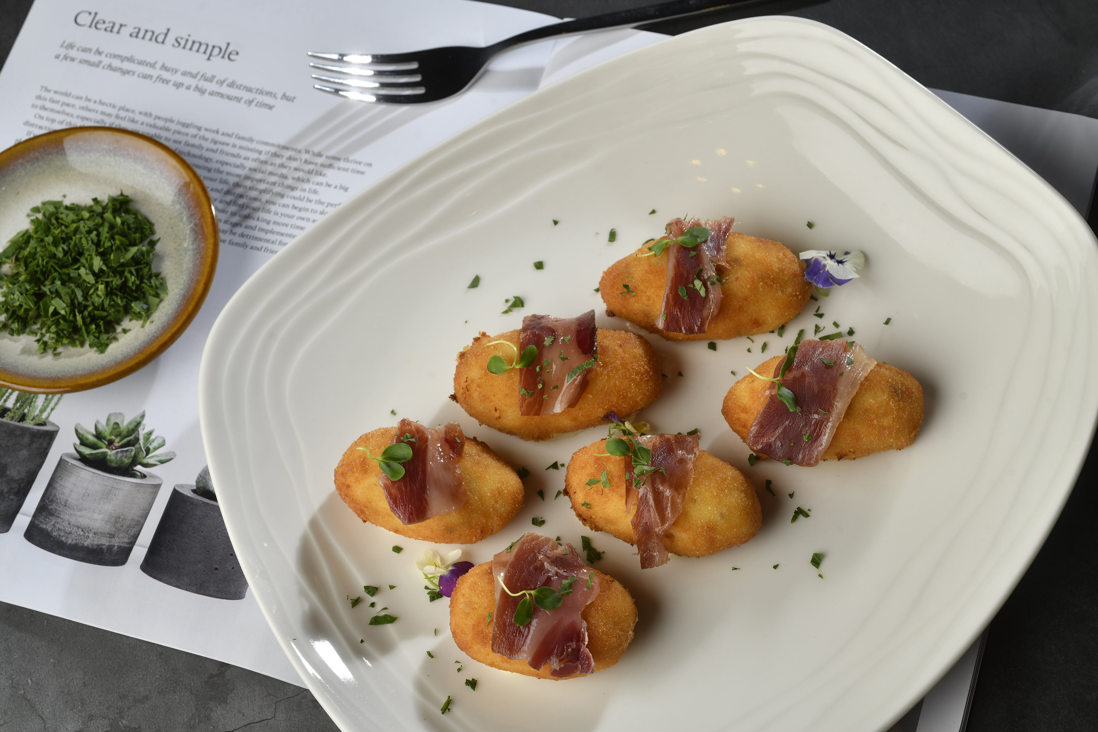 food on a plate next to a fork and knife