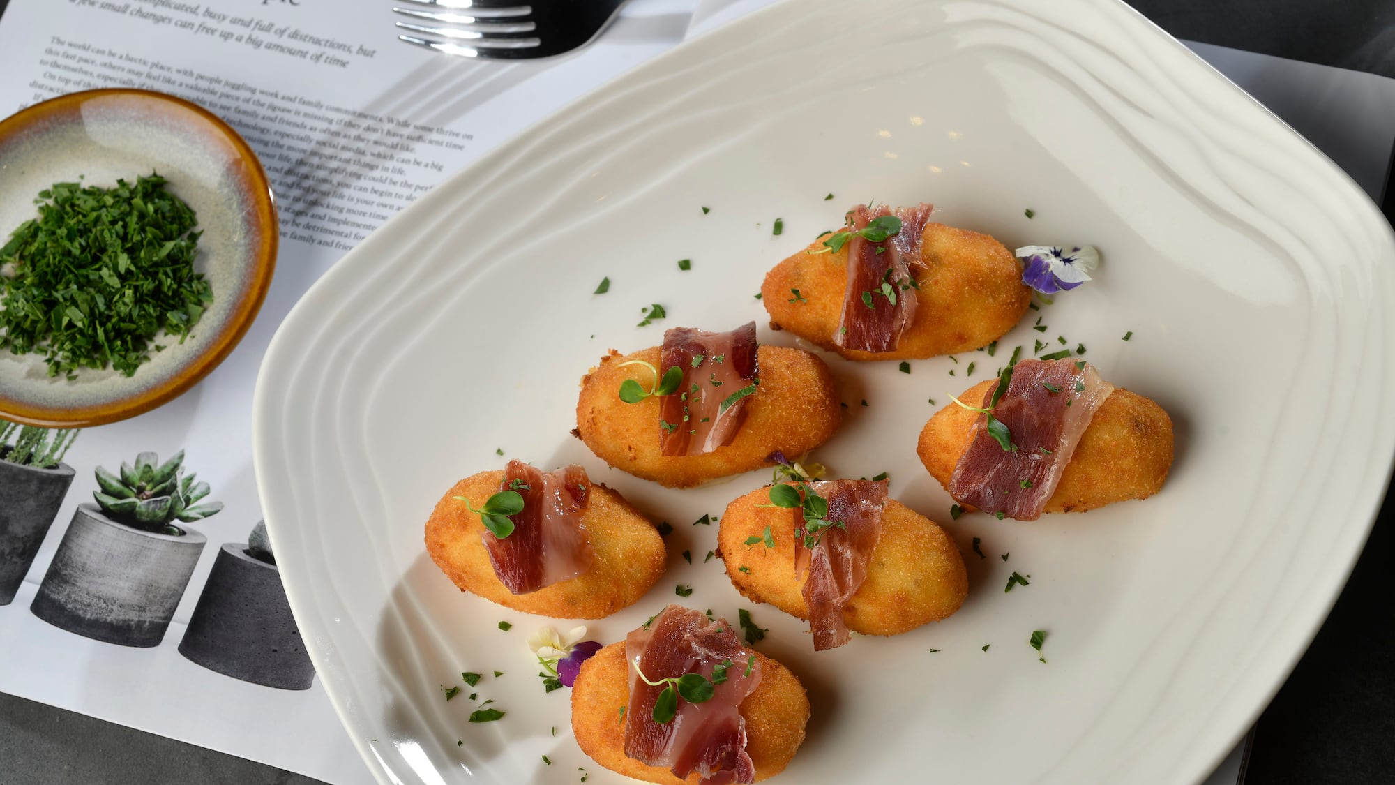 food on a plate next to a fork and knife