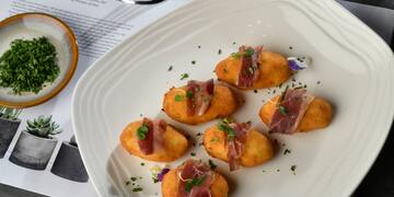 food on a plate next to a fork and knife