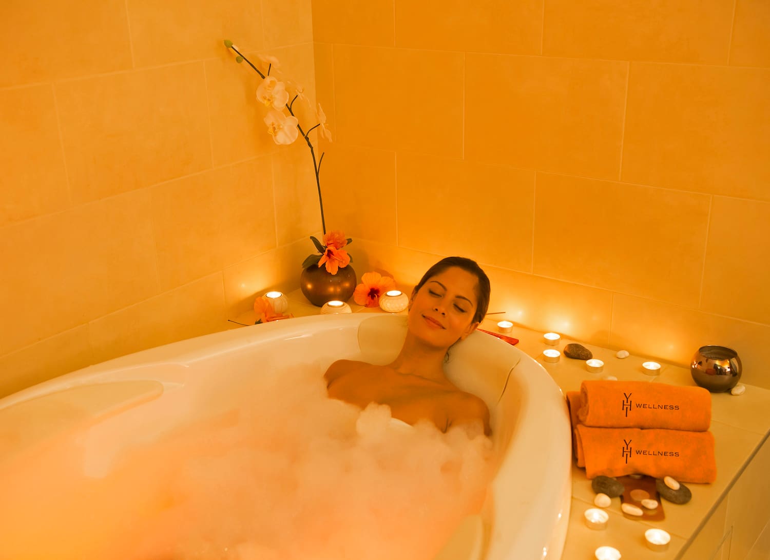 a woman lying in a bubble bath