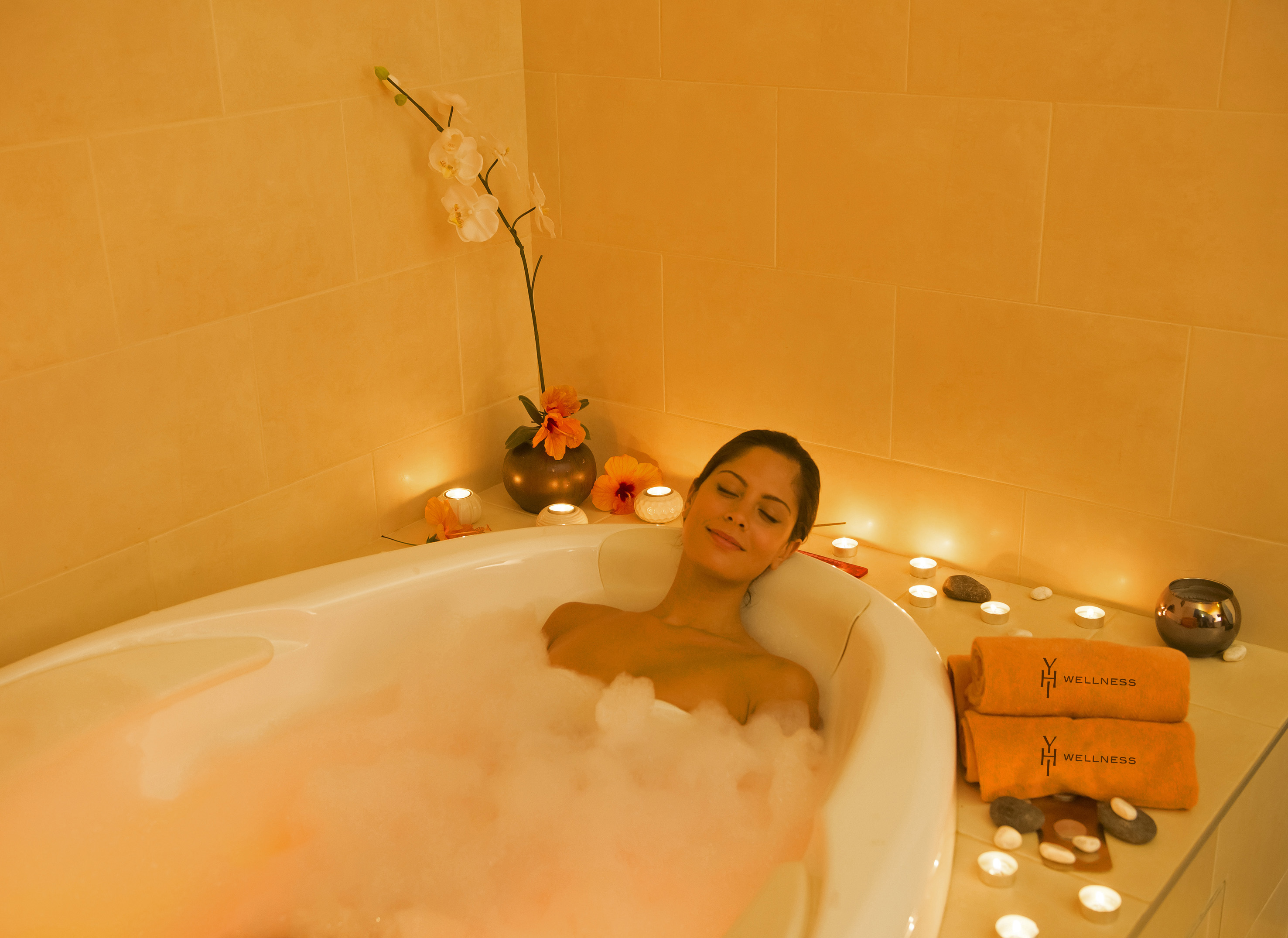 a woman lying in a bubble bath