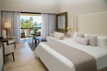 a bedroom with a large bed and a large mirror