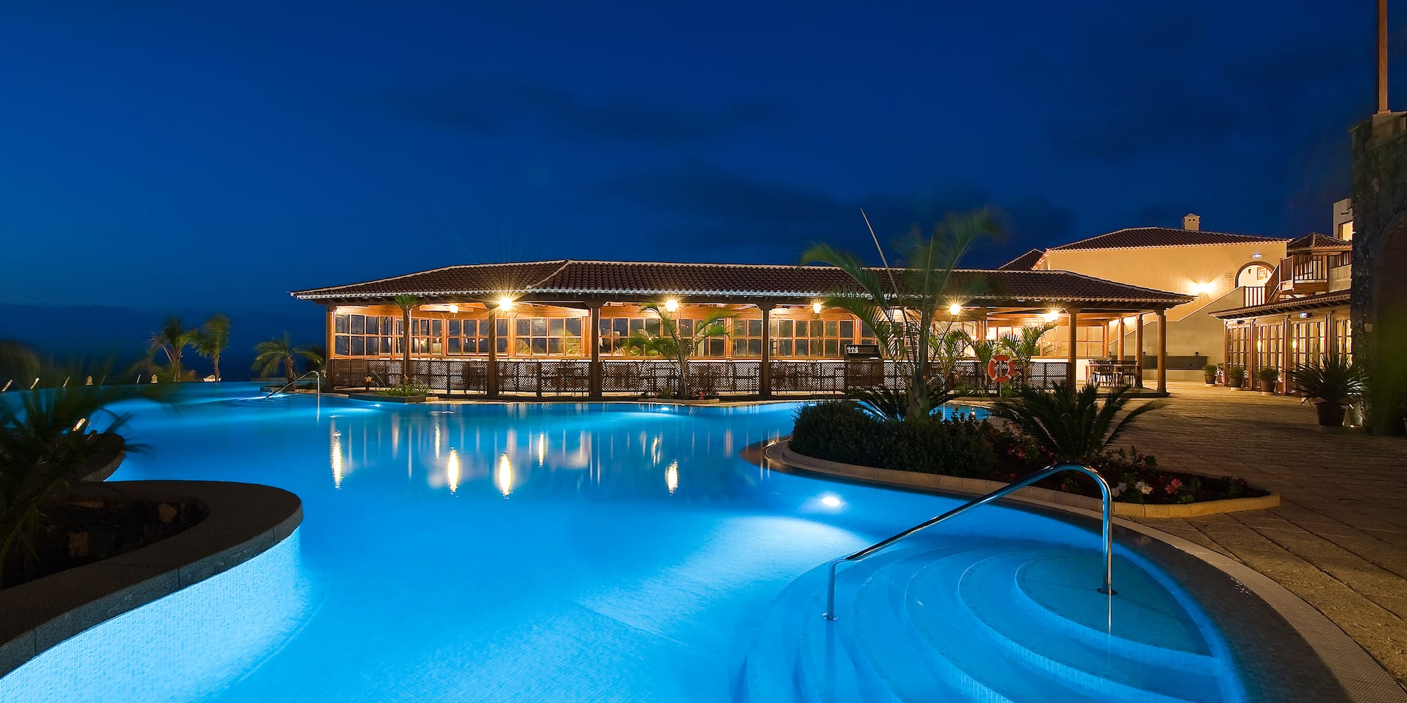 a pool with a building and a building in the background