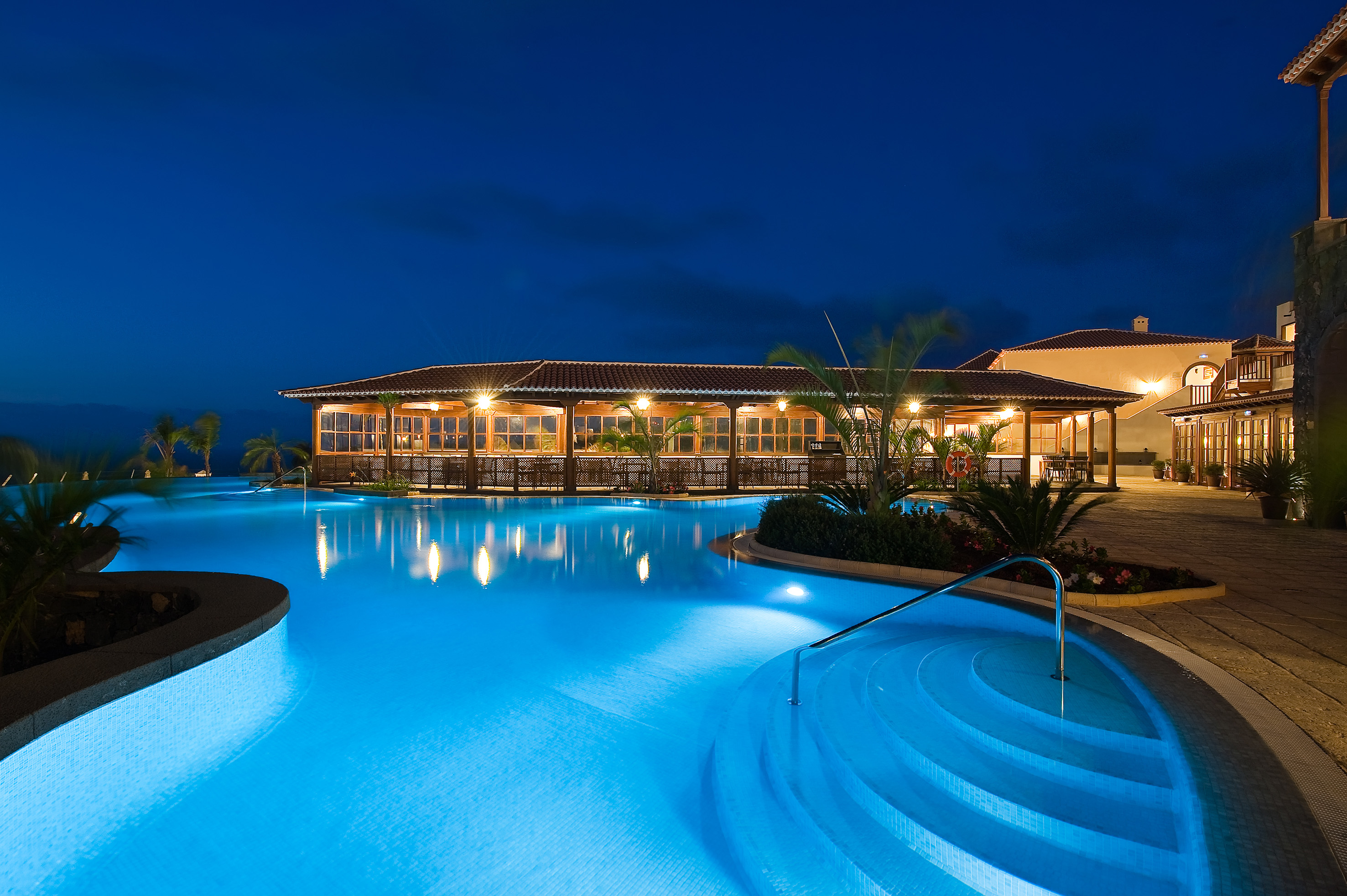 a pool with a building and a building in the background