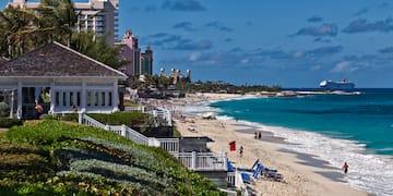 a beach with buildings and a body of water