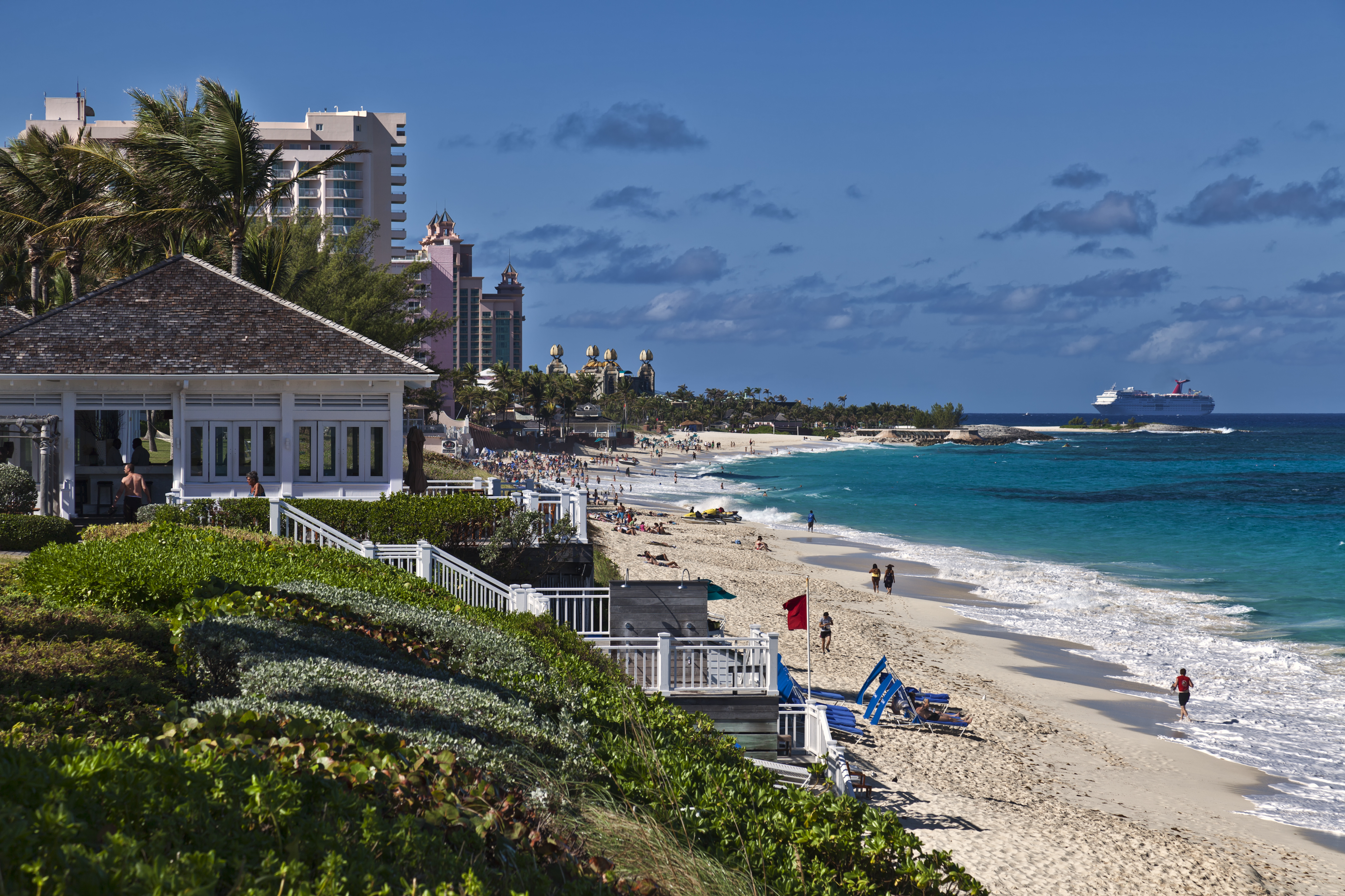 a beach with buildings and a body of water