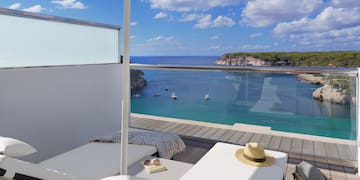 a deck with a pool and a beach view