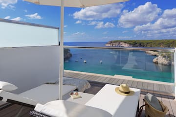 a deck with a pool and a beach view