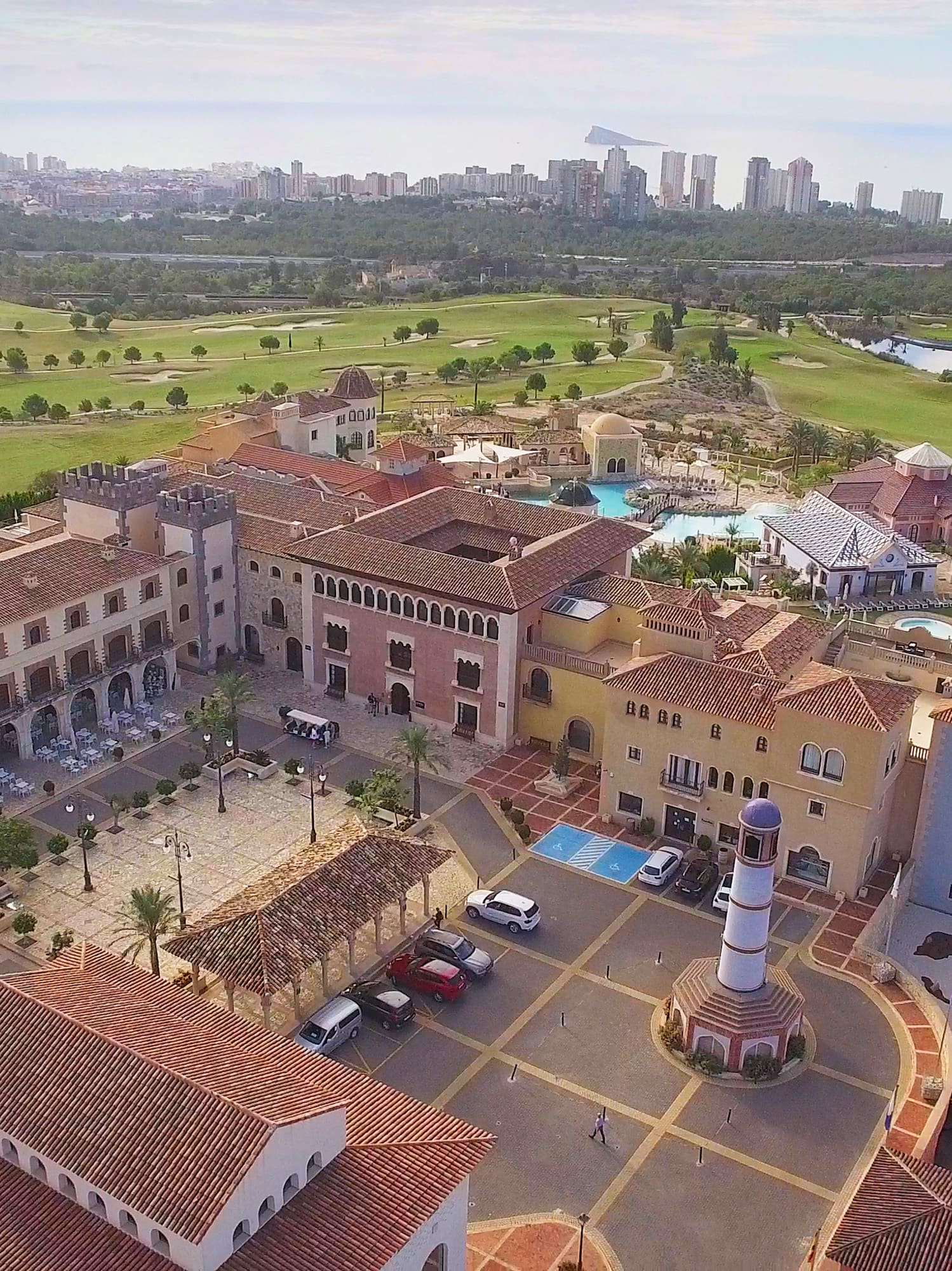 a large building with a pool and a golf course