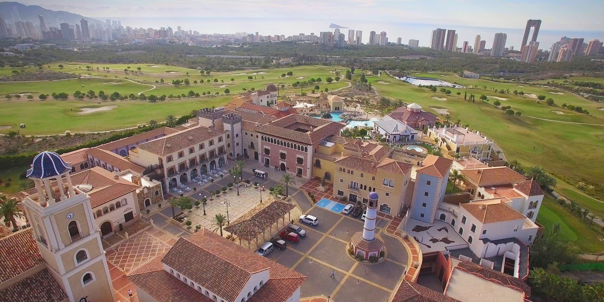 a large building with a pool and a golf course