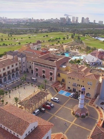 a large building with a pool and a golf course