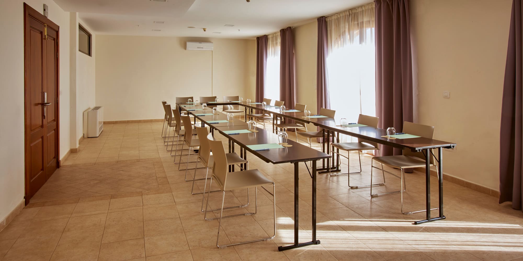 a room with long tables and chairs
