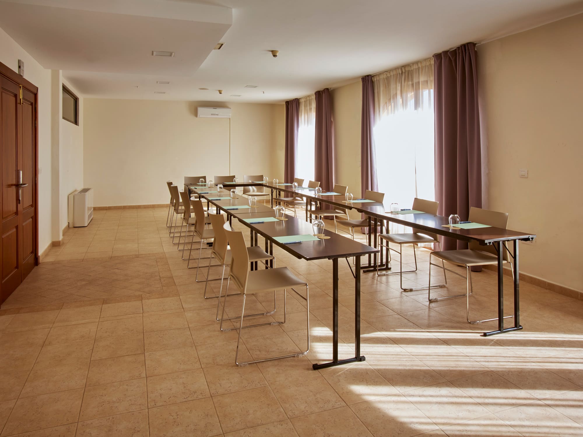 a room with long tables and chairs
