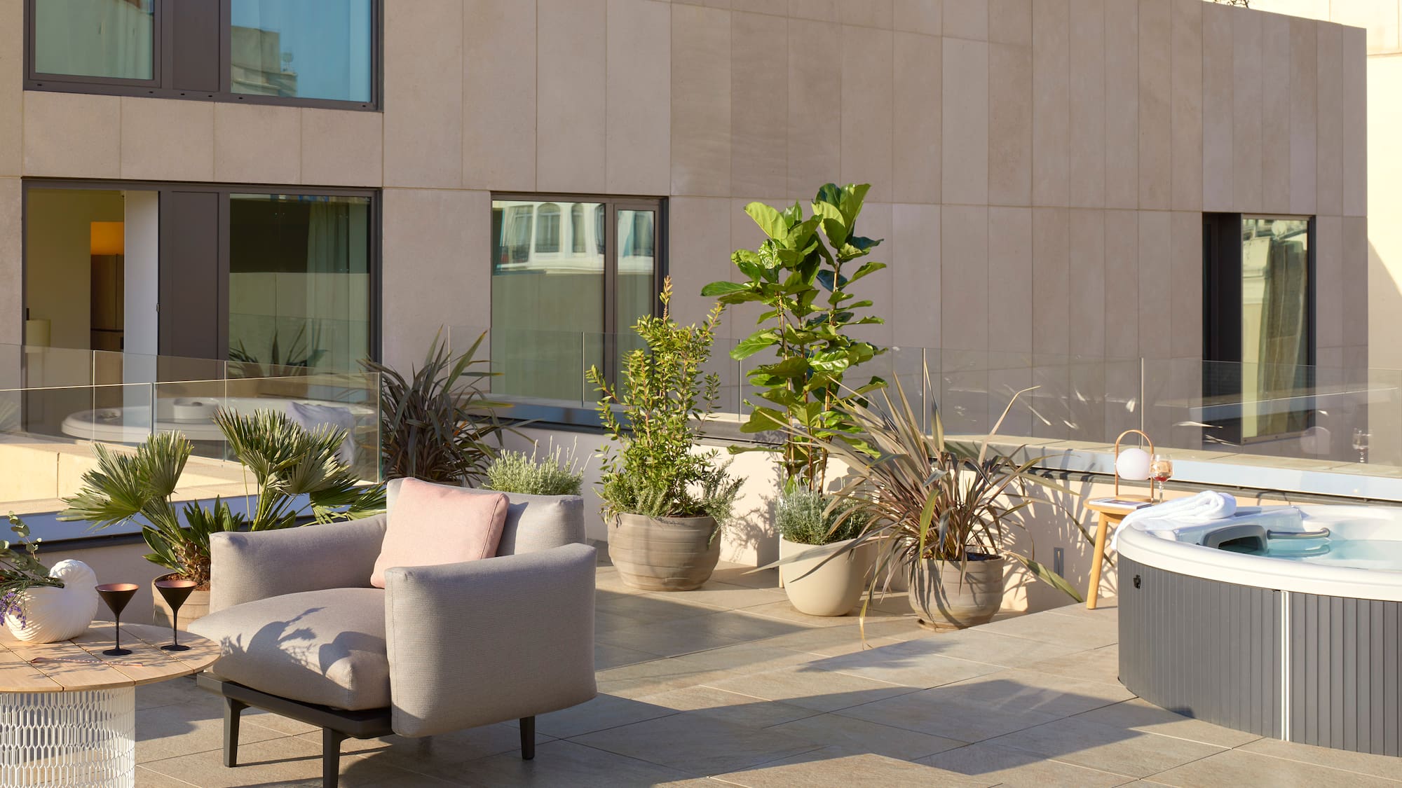 a patio with a chair and potted plants