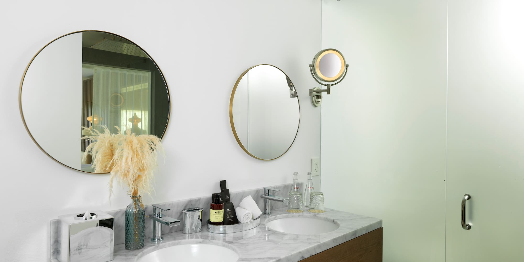 a bathroom with two mirrors