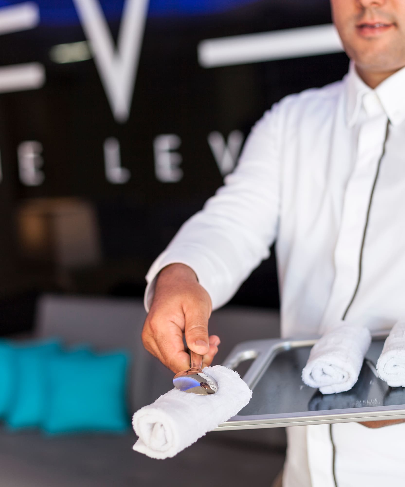 a man holding a tray with towels