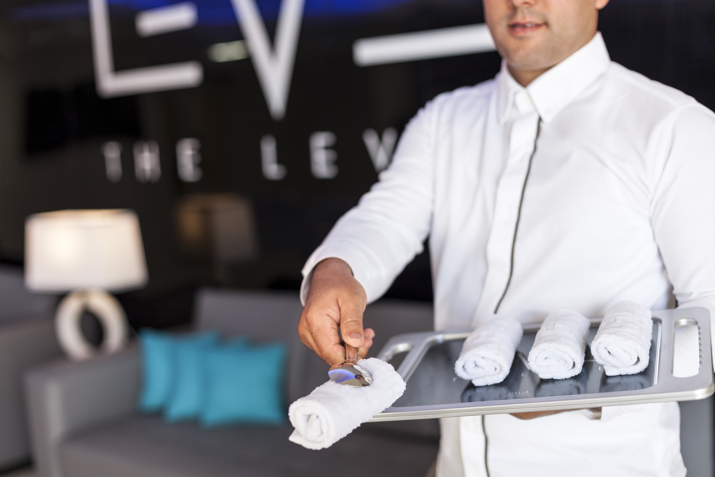 a man holding a tray with towels
